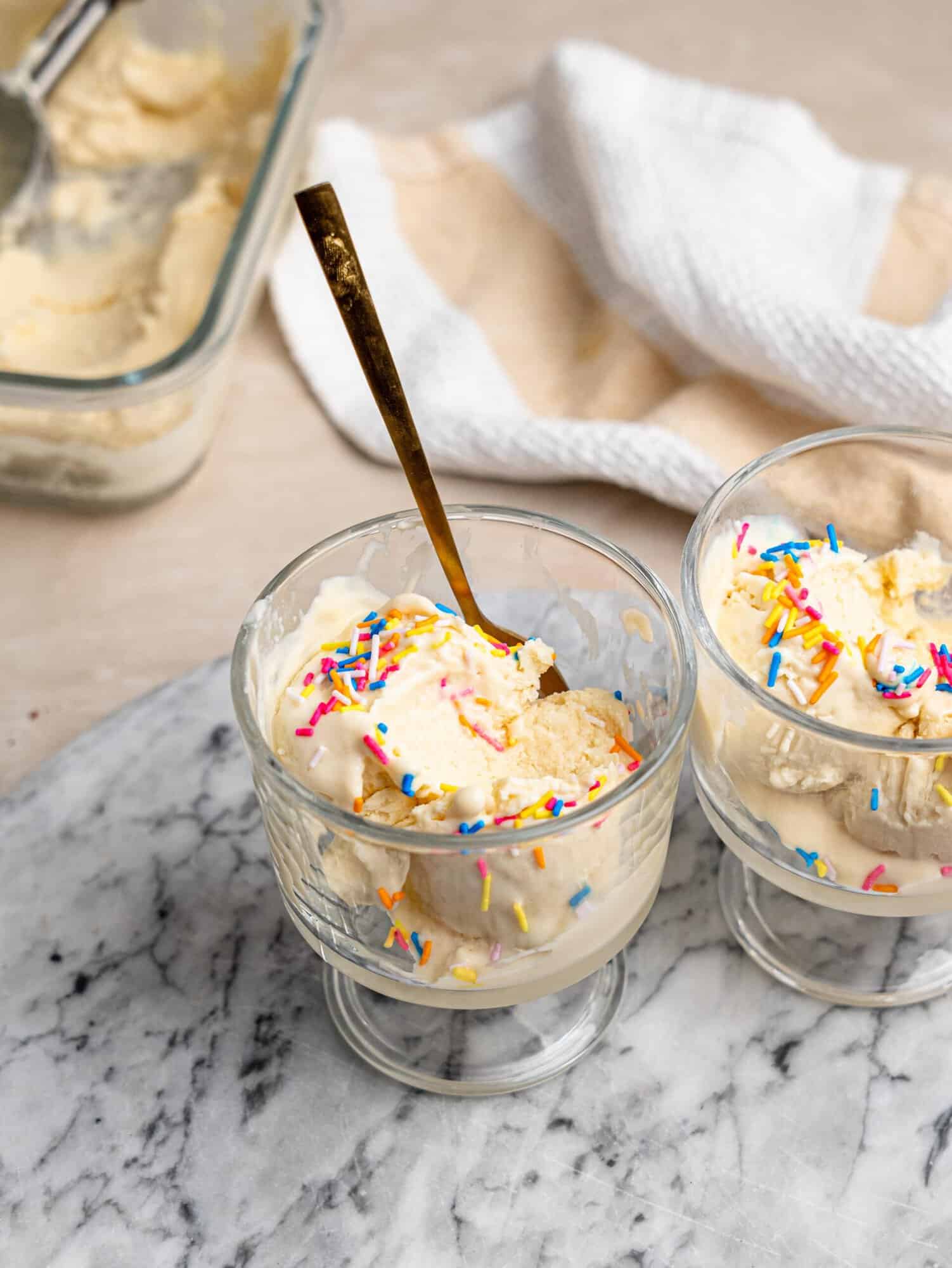 High protein ice cream served in glass dessert bowls with colorful sprinkles.